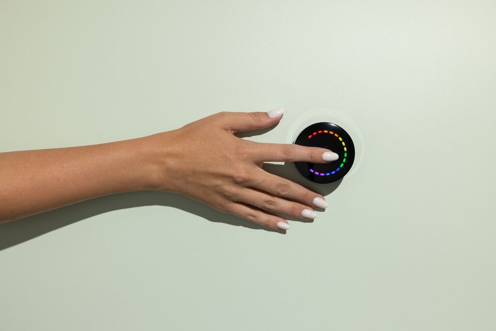 Hand placing finger on Prysm iO device